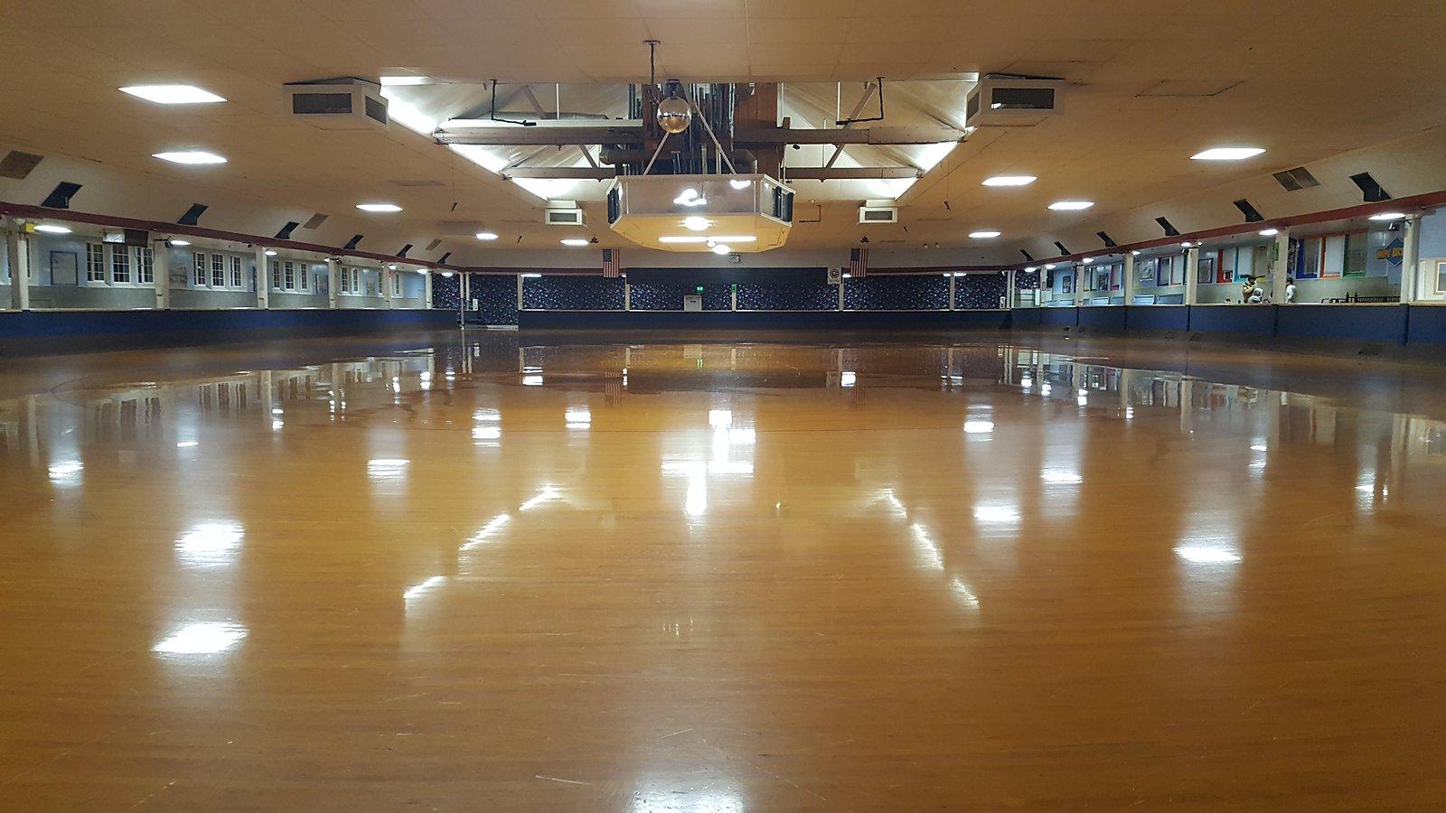 Empty roller-skating rink with a polished wood floor